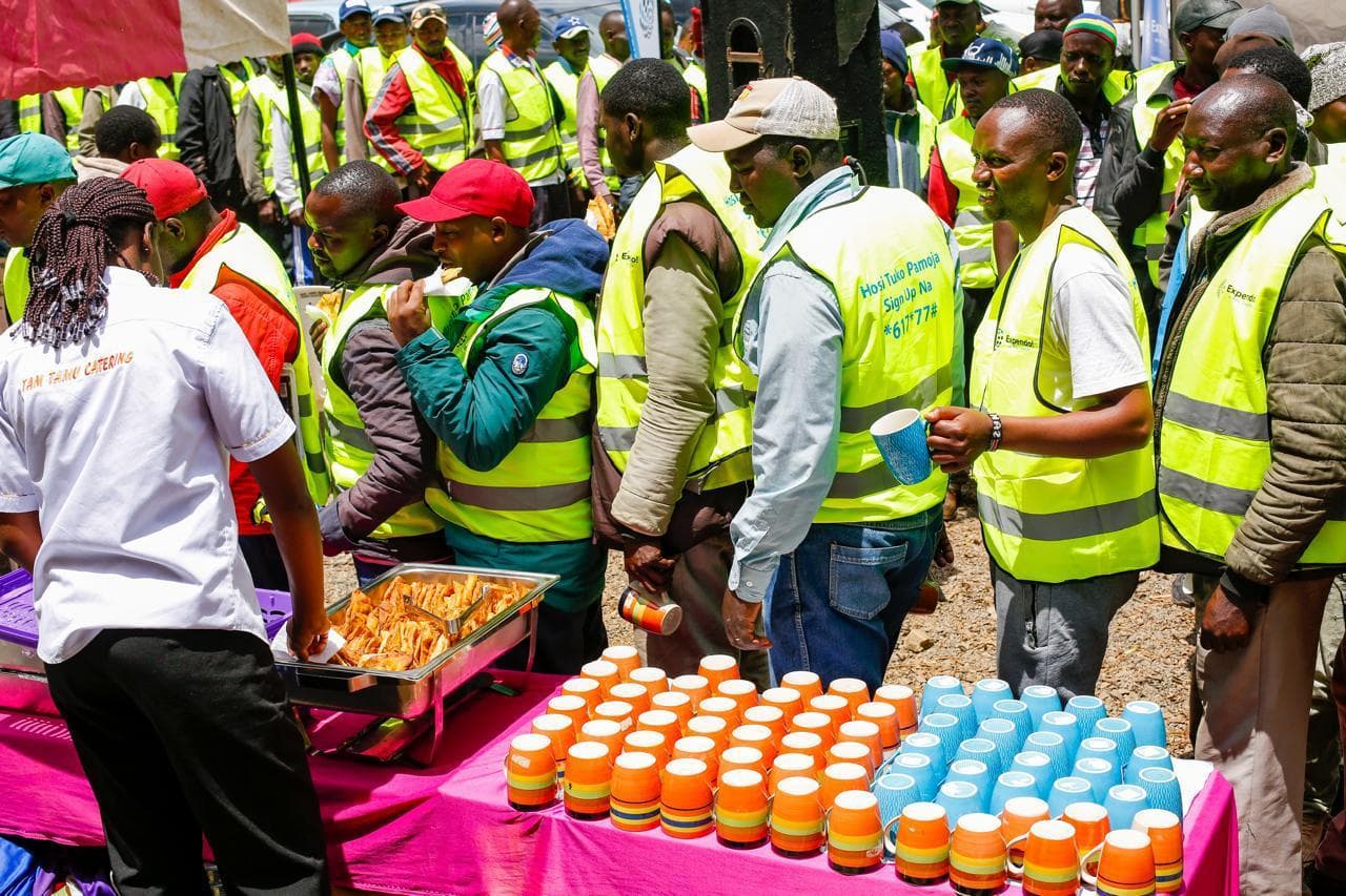 Boda boda riders getting food at a community event